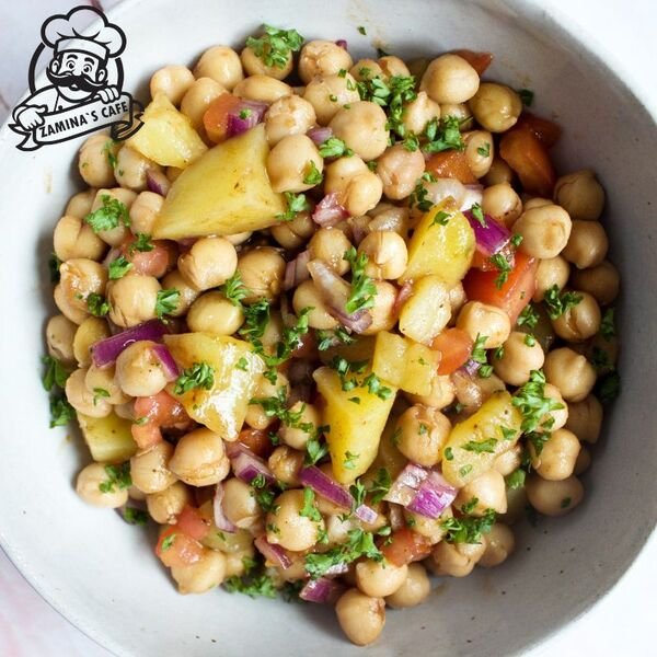 Savor our Chana Chat, a tangy and spicy asian street food made with chickpeas, vegetables, and zesty spices.