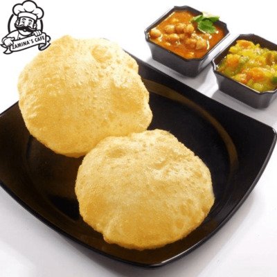 Enjoy our Poori, a traditional asian food made with deep-fried bread, served two per order, perfect for a delicious meal.