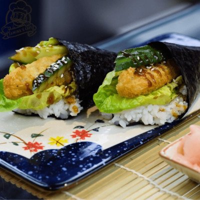 Savor our Prawn Katsu Temaki, a tasty asian seafood dish with crispy prawn katsu, avocado, and cucumber in a hand roll.