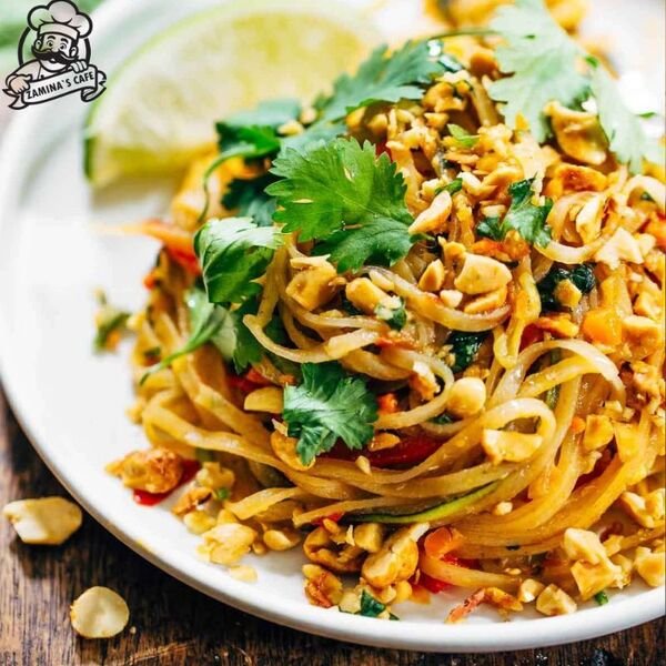 Enjoy our Veg Pad Thai, a delicious asian vegetarian meal with stir-fried noodles, vegetables, and a flavorful sauce.