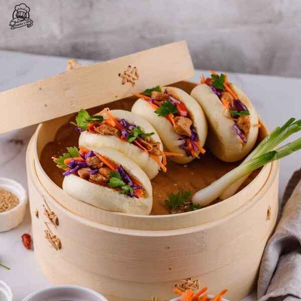 Try our Veggie Kakaige Bun, a delightful asian vegetarian meal featuring crispy vegetable fritters in a soft steamed bun.